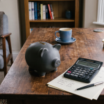A piggy bank on the table with some savings in it